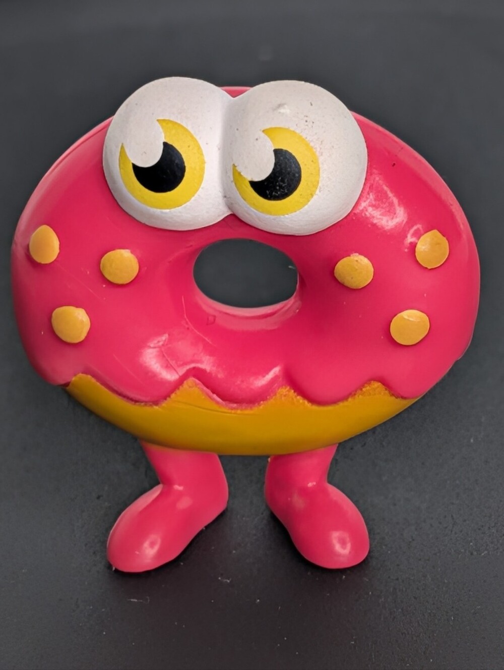 Pink donut with yellow icing and yellow sprinkles Ottie